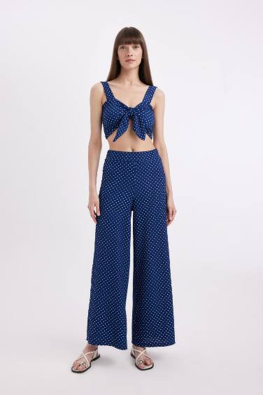 بلوزة كروب منقط بحمالات وفيونكة