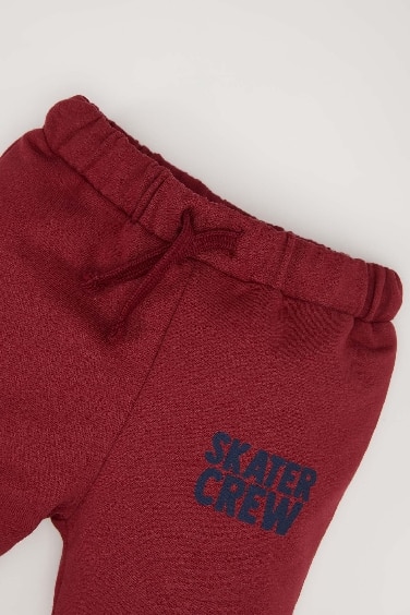 بنطلون سويت بانتس بيبي اولادي بطبعة شعار وقصة عادية خمري