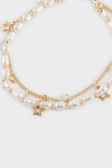 Женский браслет золотого цвета с жемчугом