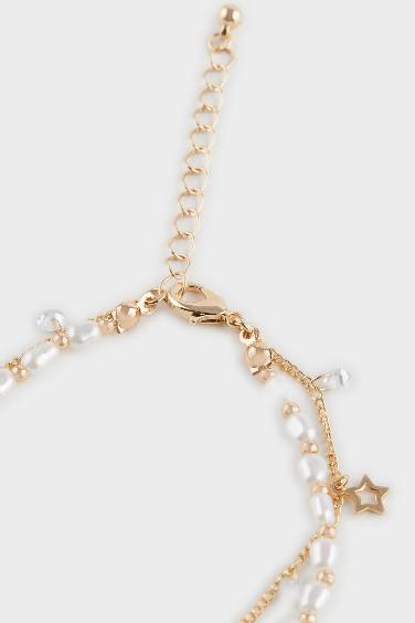 Женский браслет золотого цвета с жемчугом