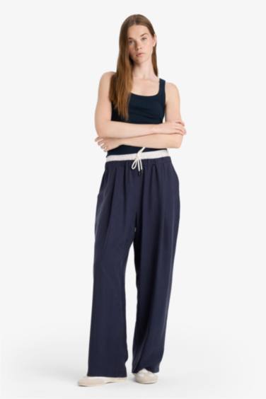 بنطرون باجي فيت قماش ايوسل بجيب وخصر عادي