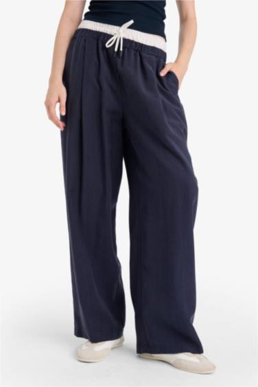 بنطرون باجي فيت قماش ايوسل بجيب وخصر عادي