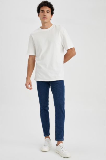 Джинсы Slim Tapered Fit приталенного кроя со средней талией