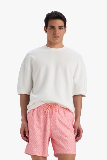 Short de bain court imprimé avec doublure en filet