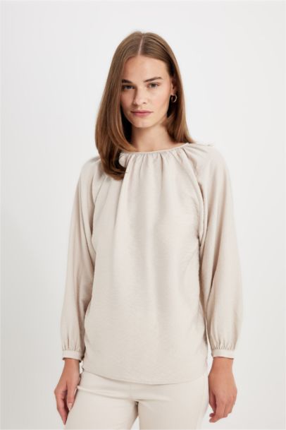 Blouse longue à col rond avec détails de boutons pour femme
