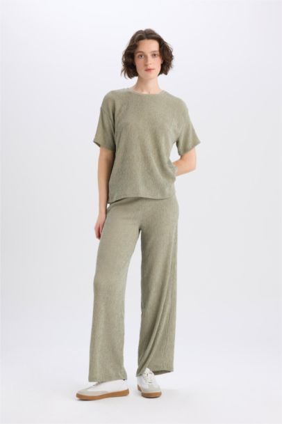 Pantalon large à jambes bouffantes en tissu plissé