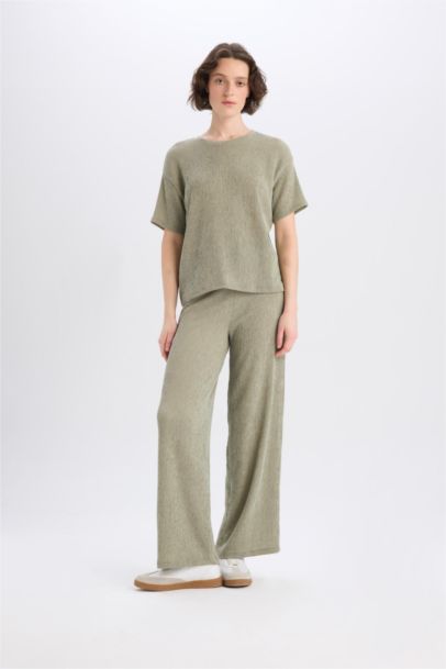 Pantalon large à jambes bouffantes en tissu plissé