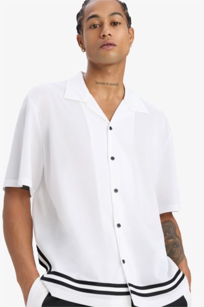 تيشيرت بولو نص ردن اوفر سايز بطبعة من الخلف