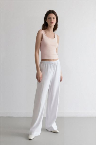 Pantalon palazzo blanc taille haute à jambes larges avec poches