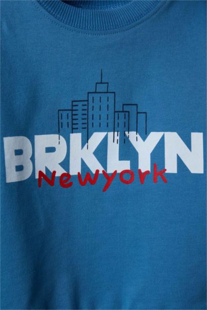 سويت شيرت بيبي ولادي اوفر سايز منقوش - قطعتين