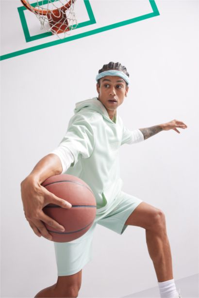 تيشيرت رياضي اوفر سايز نص كم بكابيشون من DeFactoFit