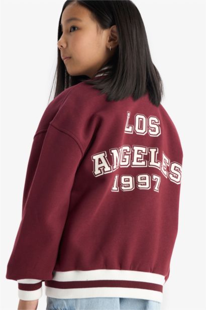 كارديجان بناتي اوفر سايز تقيل بطبعة شعار برقبة مستديرة