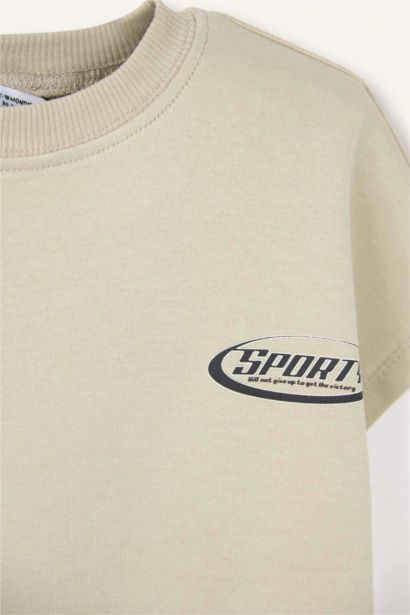 تيشيرت بيبي اولادي اوفر سايز نص كم بطبعة شعار