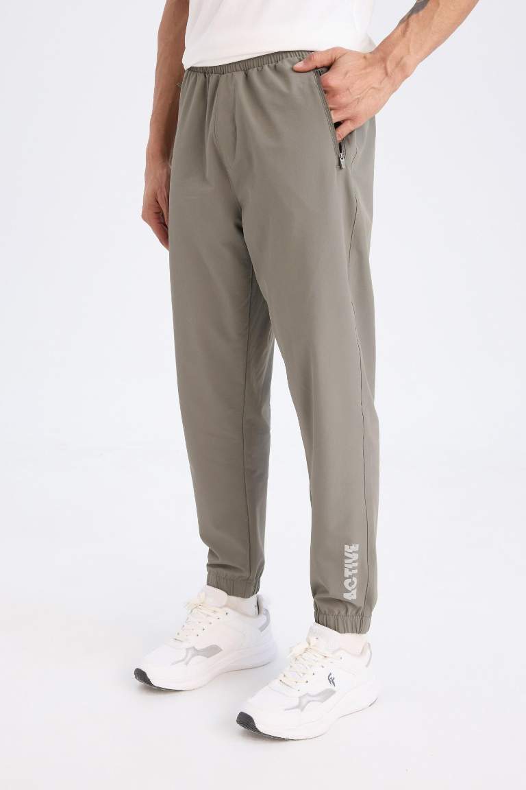 DeFactoFit Dokuma Esnek Multifonksiyonel Sporcu Jogger Eşofman Altı Slim Fit Dar Kesim Çift Cepli