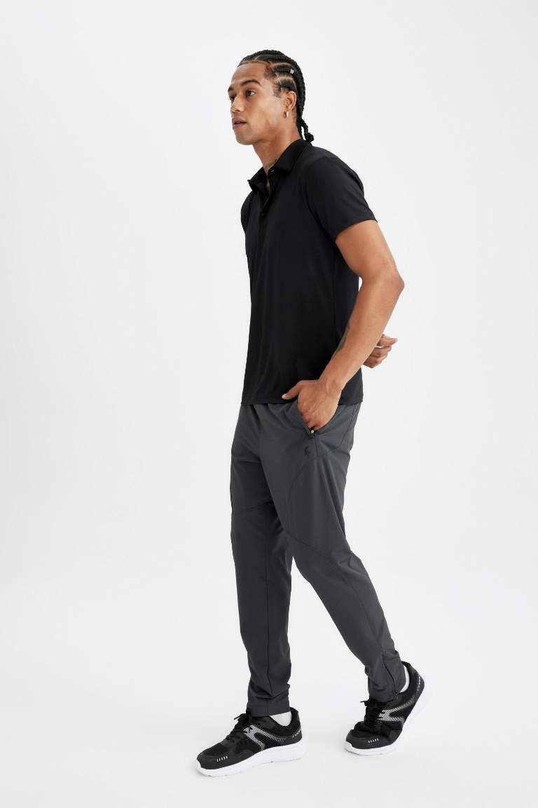 DeFactoFit Sporcu Dokuma Pantolon Slim Fit Dar Kesim Çift Cepli Fermuarlı Paça