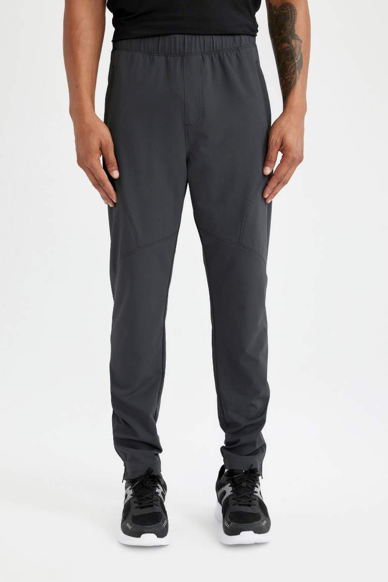 DeFactoFit Sporcu Dokuma Pantolon Slim Fit Dar Kesim Çift Cepli Fermuarlı Paça