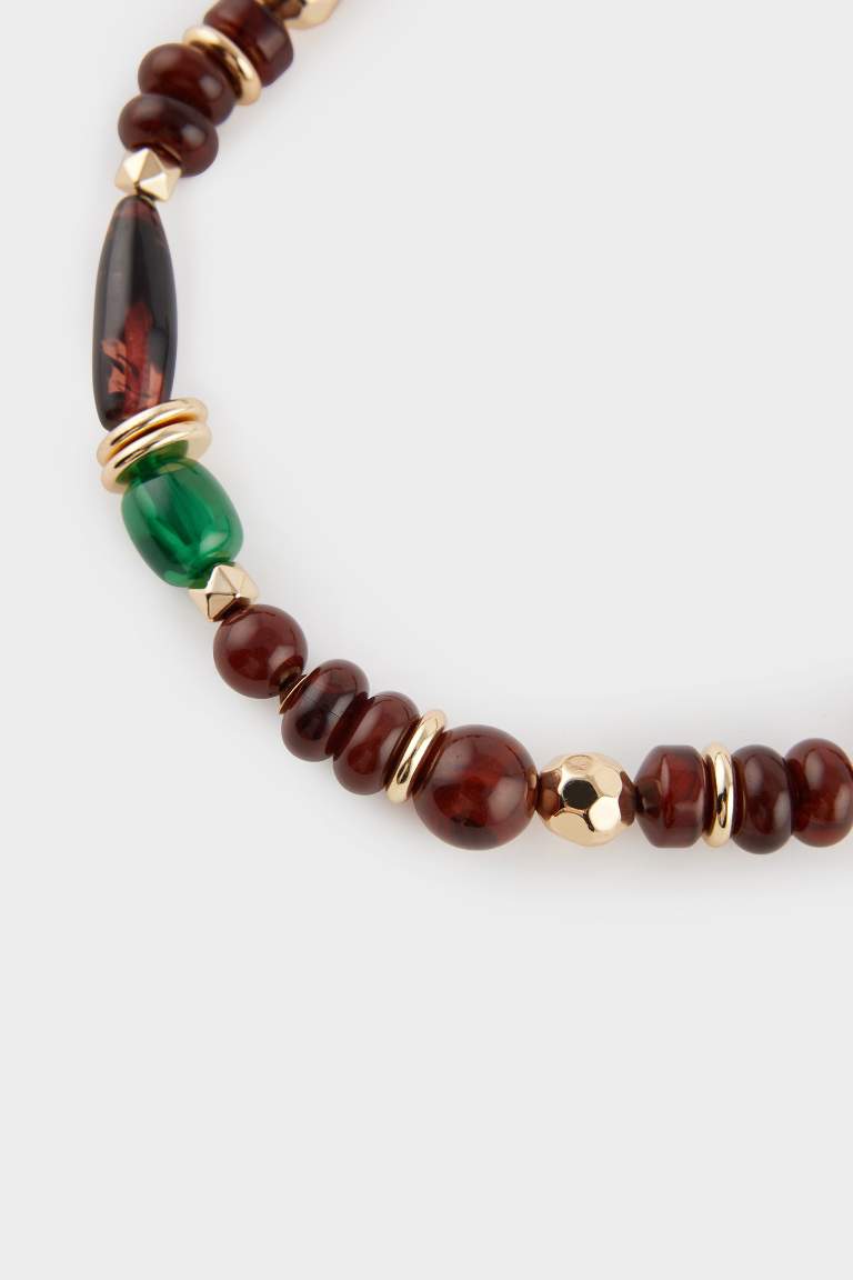 Collier doré avec pierres marron et vertes pour femme