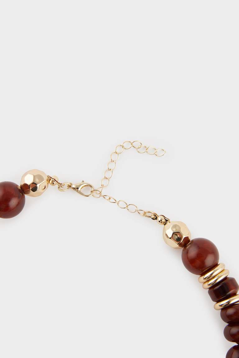 Collier doré avec pierres marron et vertes pour femme
