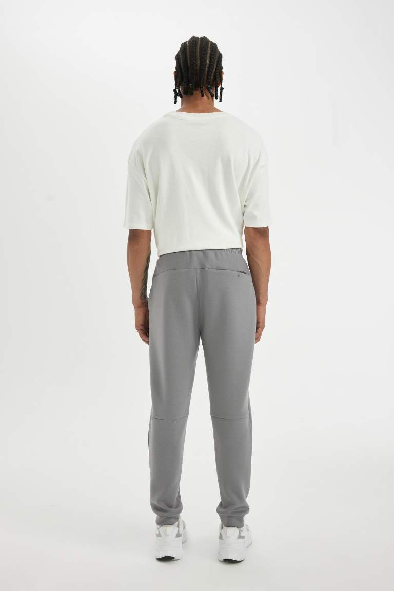 DeFactoFit Slim Fit Sporcu İnce Jogger Eşofman Altı Dar Kesim Skuba Dalgıç Kumaş Standart Paça Beli Bağcıklı Lastikli Paça