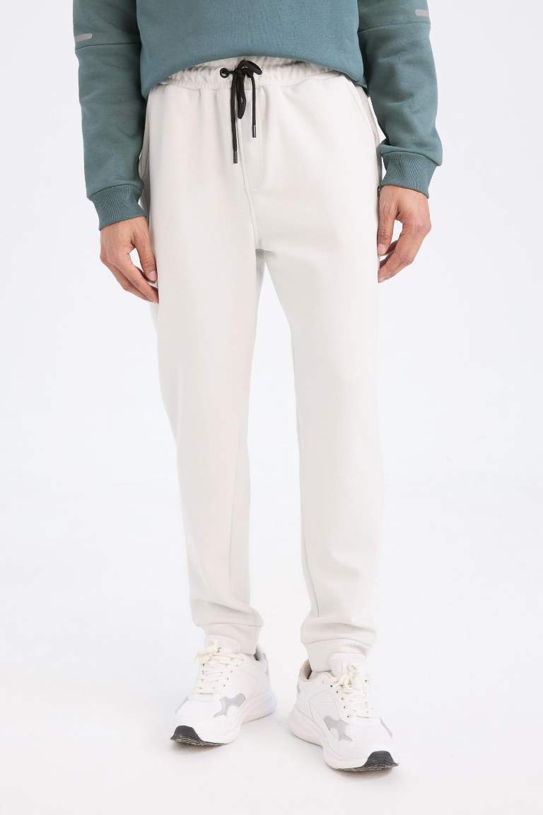 DeFactoFit Slim Fit Sporcu İnce Jogger Eşofman Altı Dar Kesim Skuba Dalgıç Kumaş Standart Paça Beli Bağcıklı Lastikli Paça