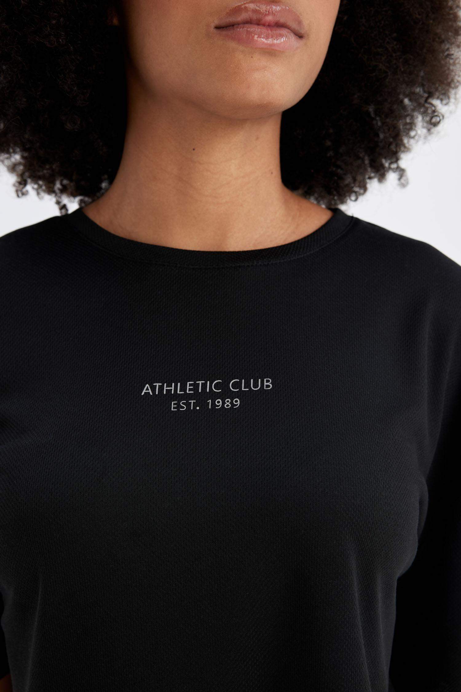 تيشيرت رياضي اوفر سايز نص ردن بطبعة شعار من DeFactoFit