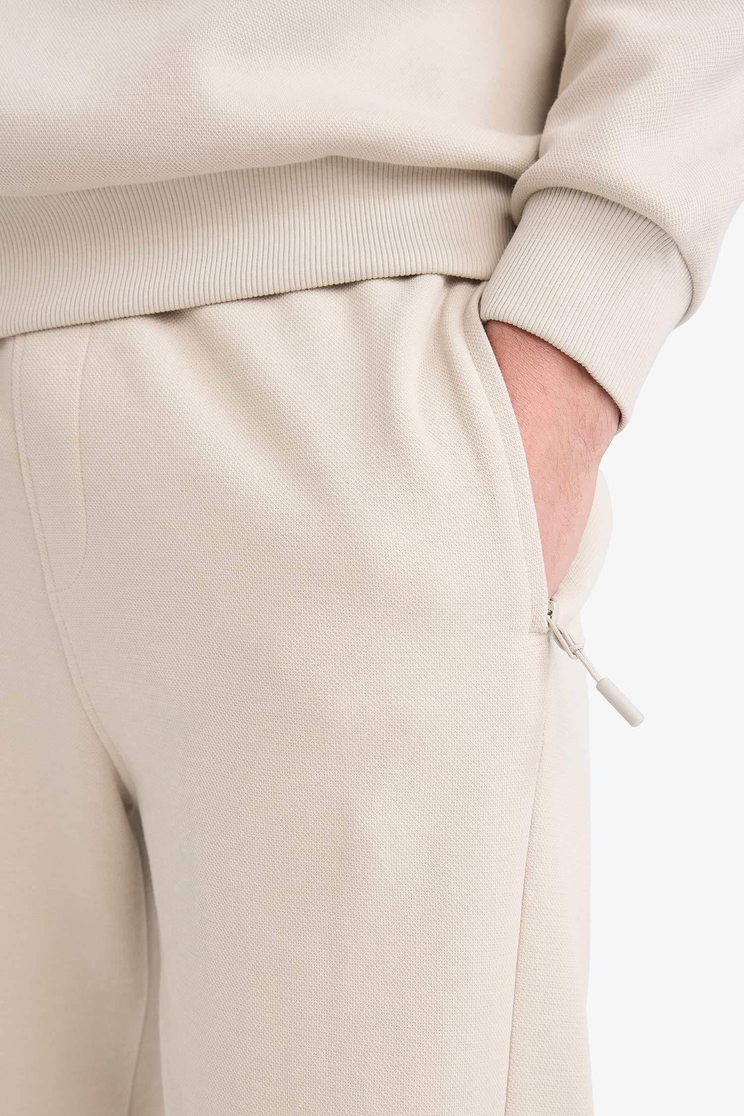 Pantalon de survêtement slim fit en piqué à poches zippées