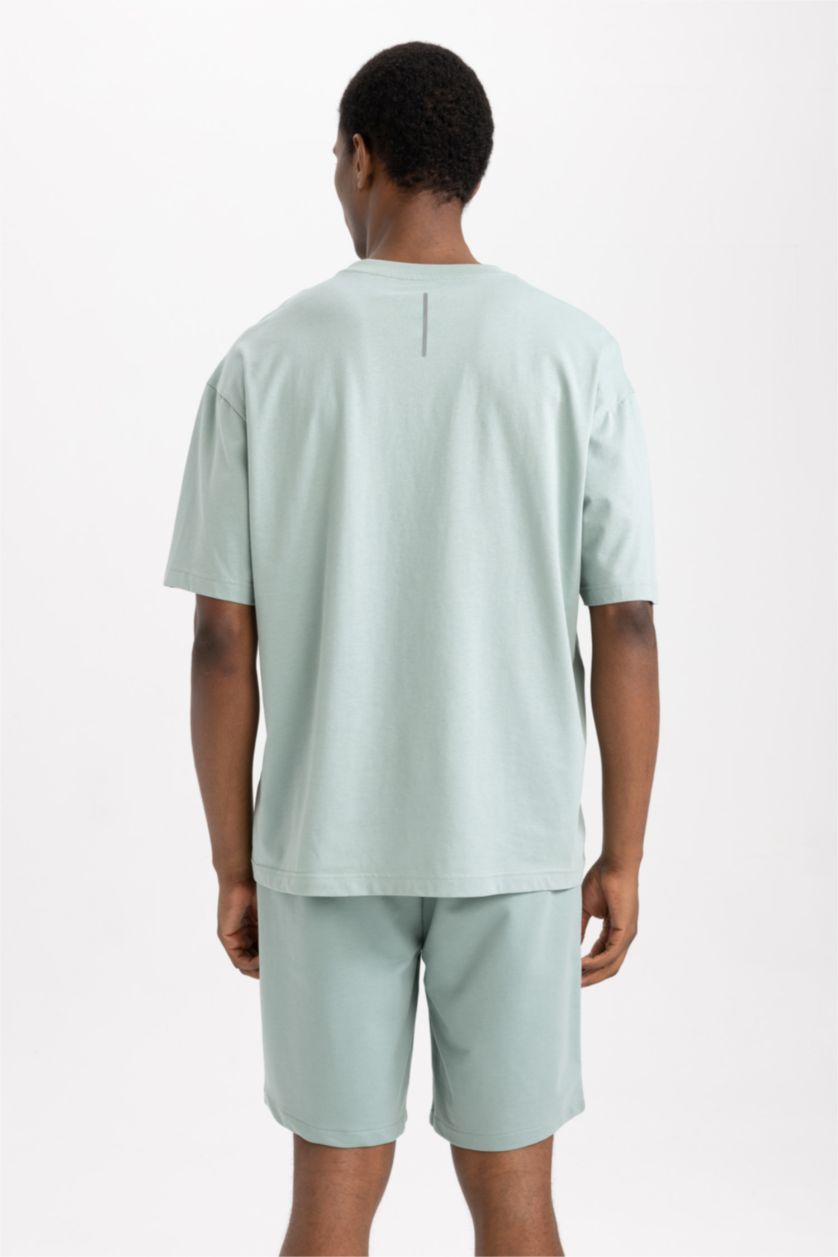 رجال أخضر فاتح تي شيرت نص ردن اوفر سايز مطبوع بياخة مستديرة من DeFactoFit