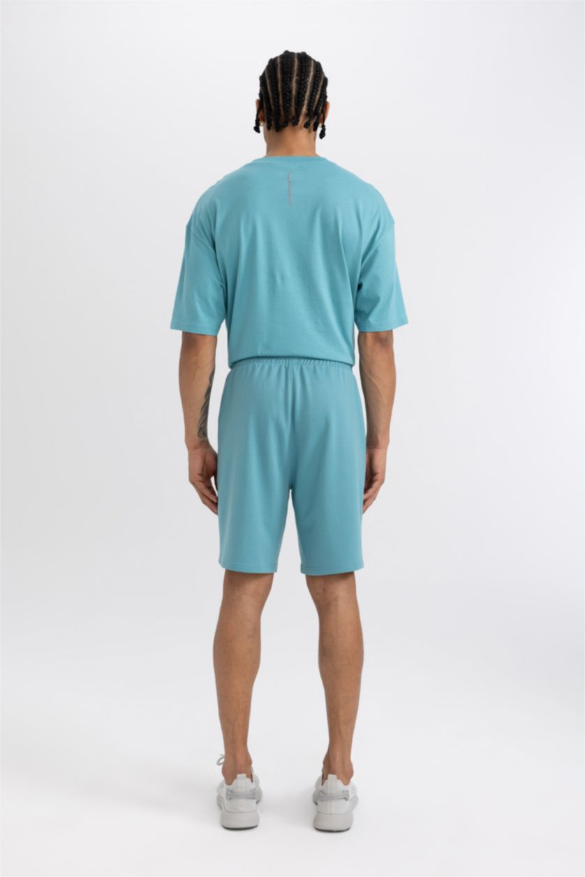 رجال فيروزي فاتح شورت قصير سليم فيت بجيب مزدوج من DeFactoFit