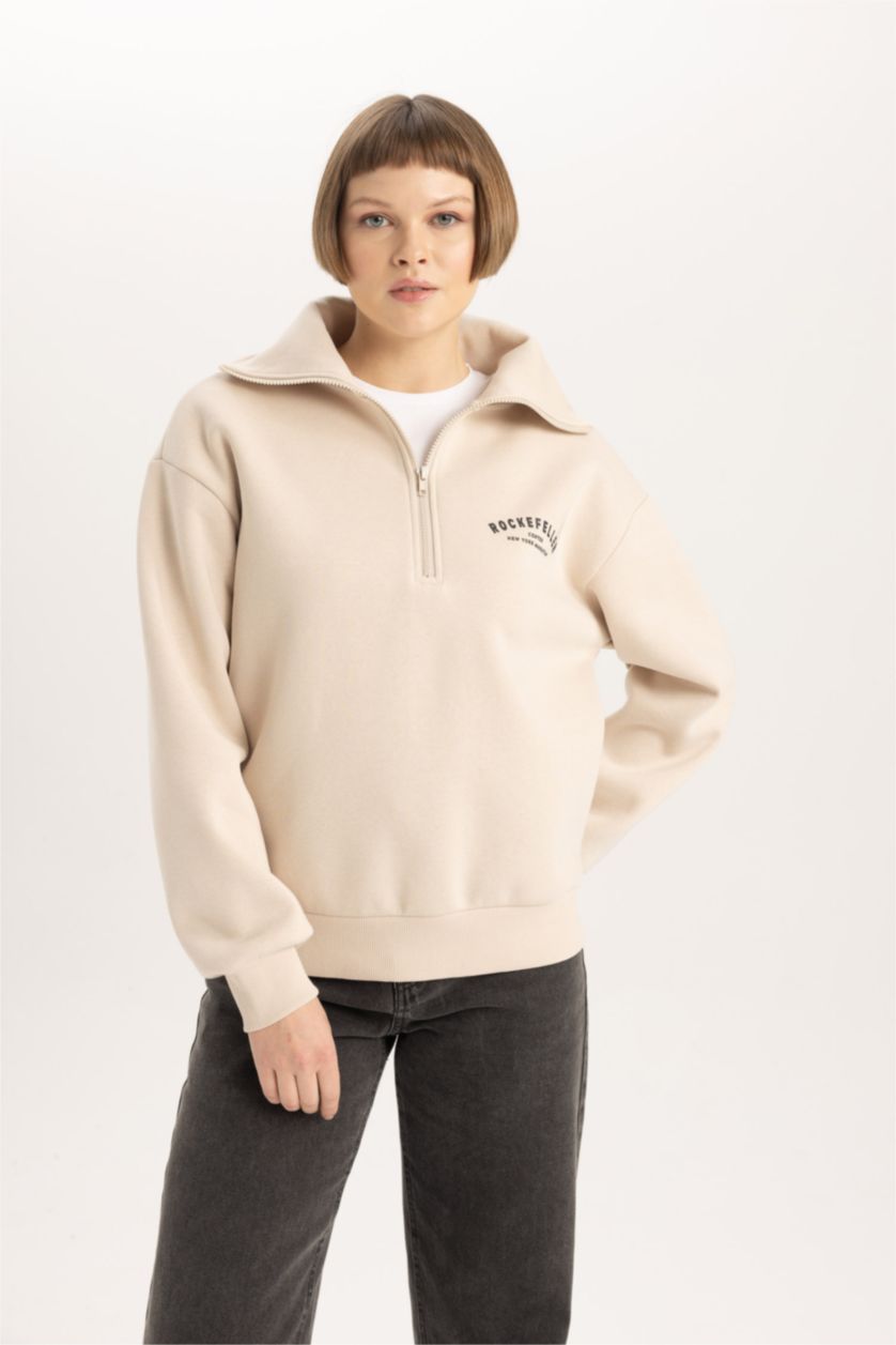 حريمي بيج سويت شيرت بطبعة شعار قصة مريحة بياقة نص سوسته