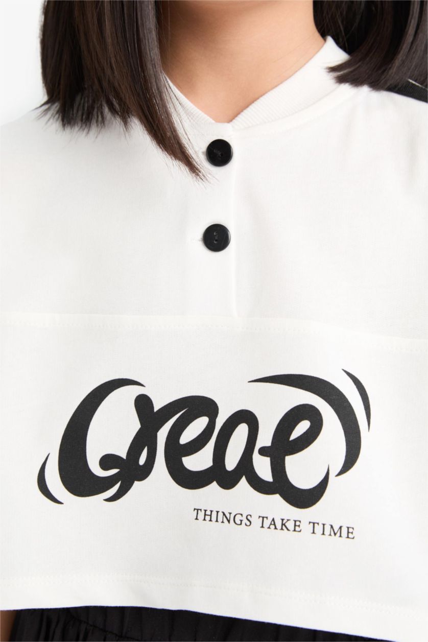 بنات بيج فاتح تيشيرت بناتي نص ردن بطبعة شعار بياخة مستديرة