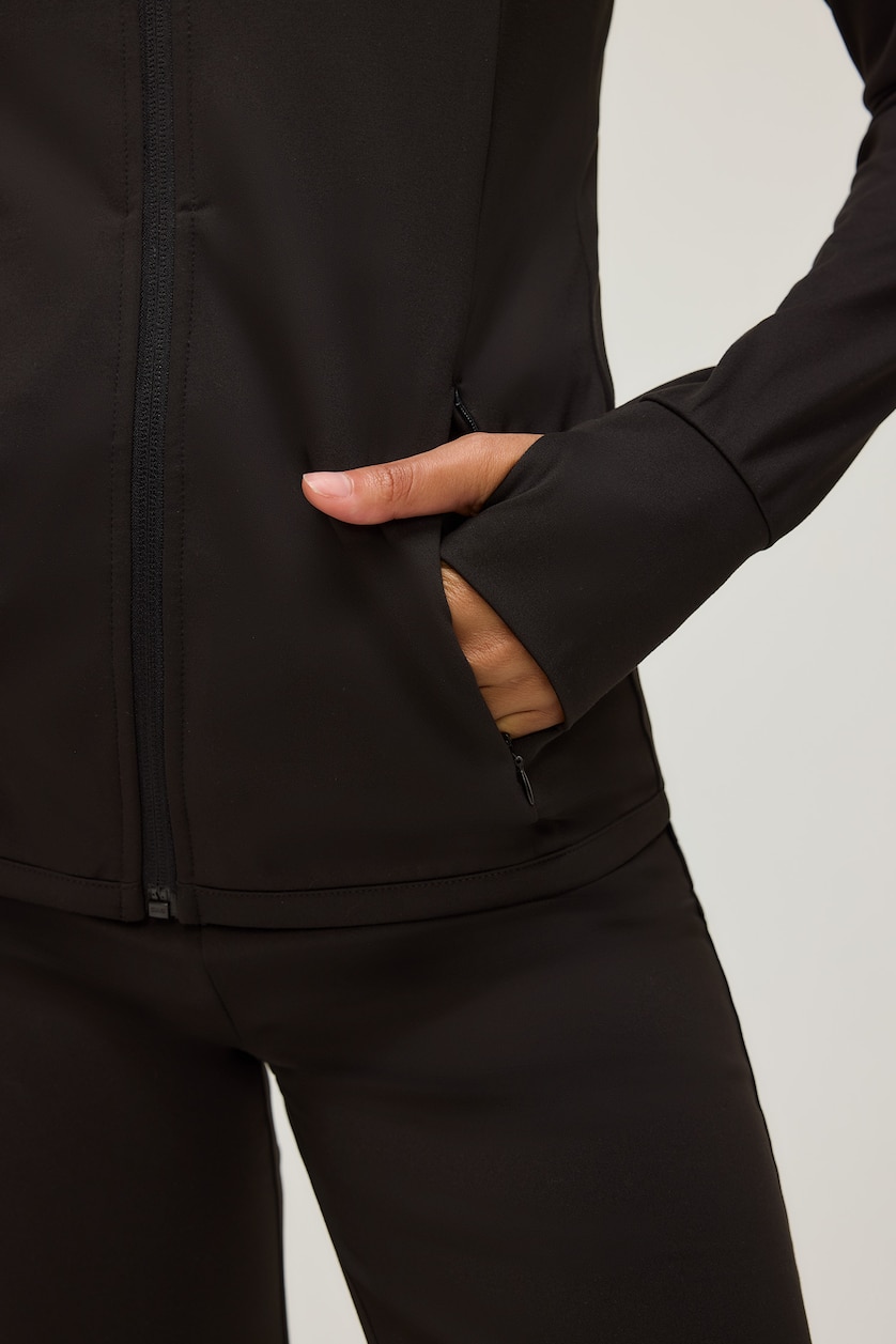 FEMME Noir Top de sport ajusté à col montant et manches raglan avec fermeture zip