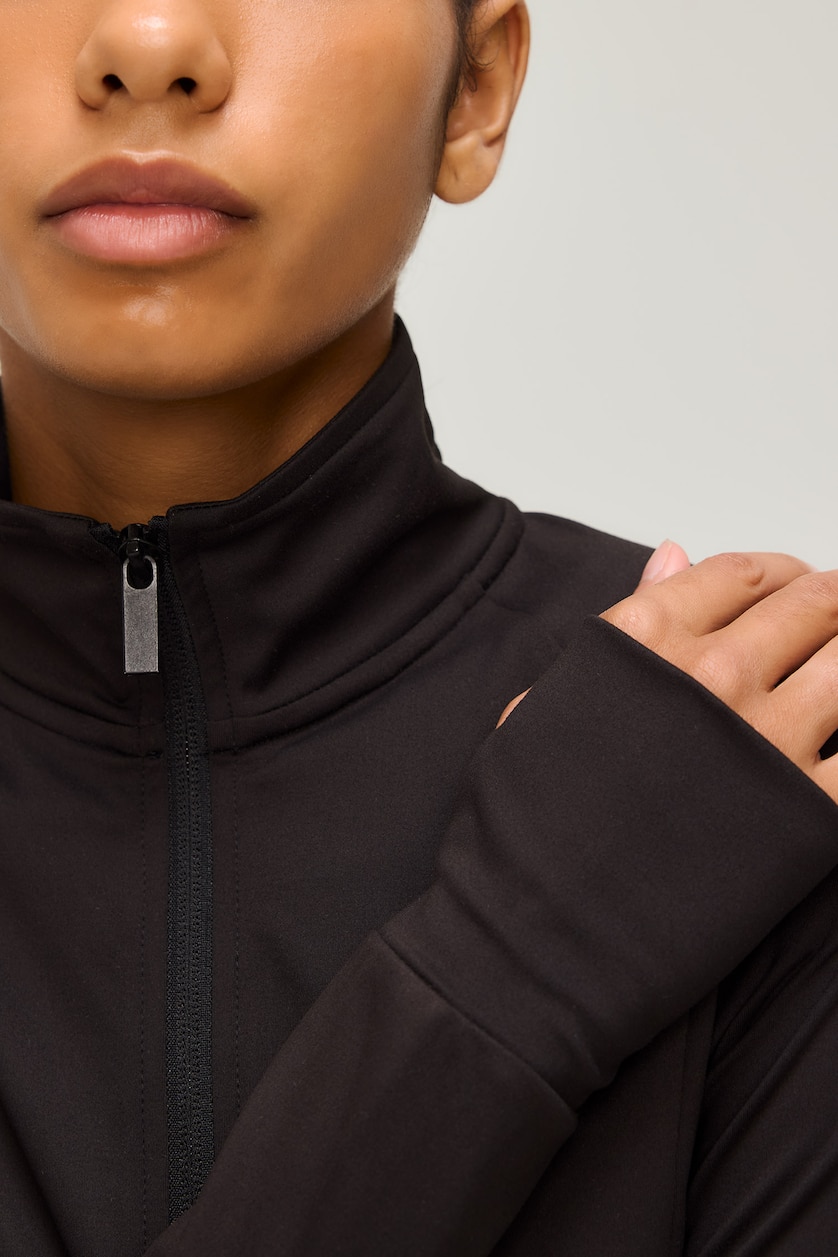 FEMME Noir Top de sport ajusté à col montant et manches raglan avec fermeture zip