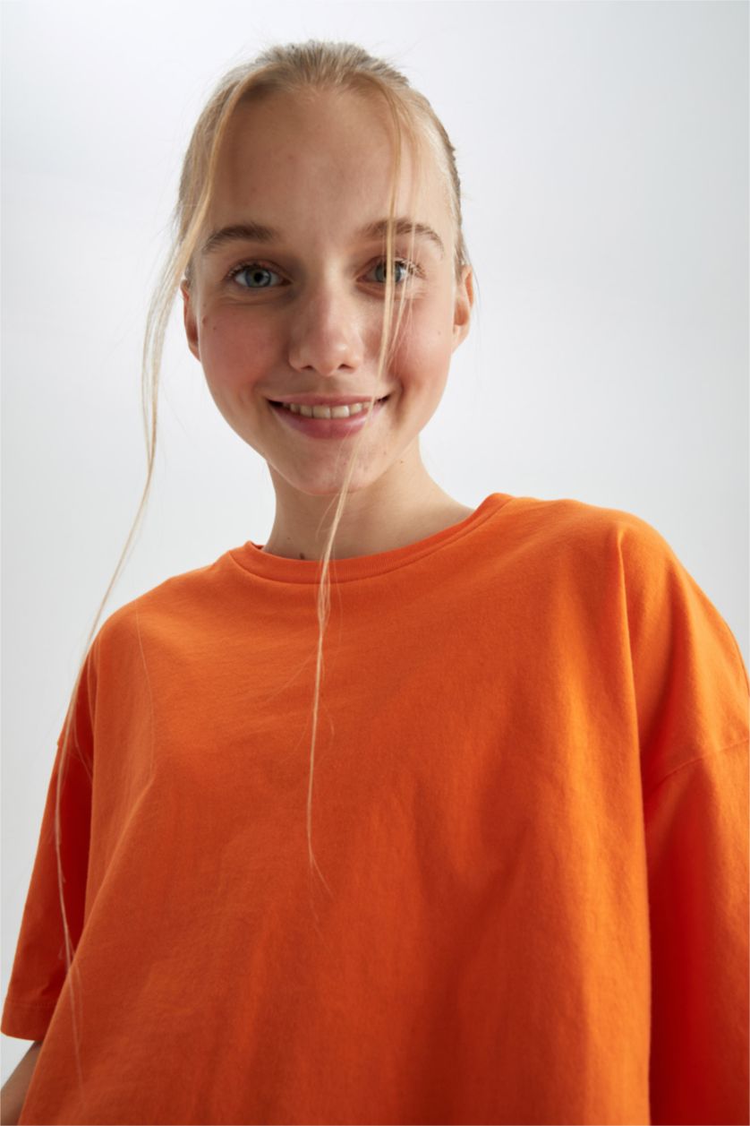 حريمي برتقالي تي شيرت قطن بأكمام قصيرة وقصة فضفاضة